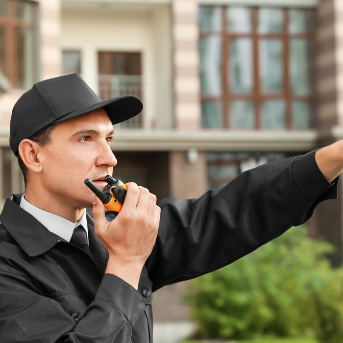 Security guard patrolling with radio